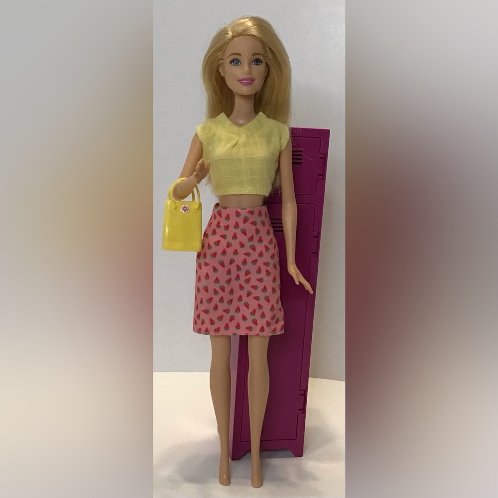 Barbie with Strawberry skirt yellow shirt and purse.